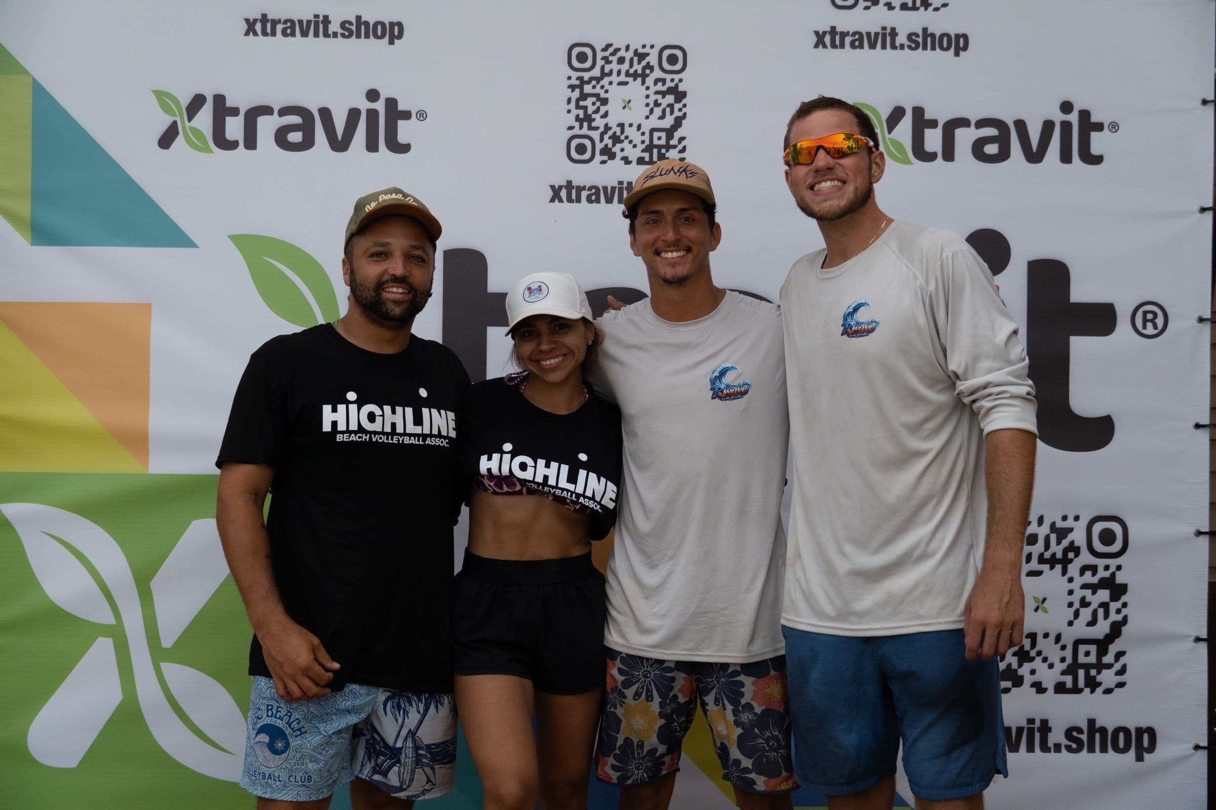Highline staff and winners in front of a sponsor step and repeat at AVP Next Puerto Rico